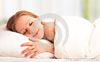 Beautiful woman sleeping and smiles in his sleep in bed Stock Photo