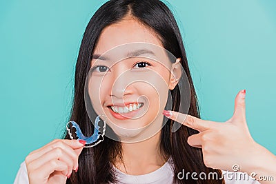 beautiful woman smiling pointing with finger silicone orthodontic retainers Stock Photo