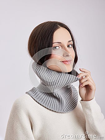 Beautiful woman in a Snood scarf on a white background. Autumn warm clothing Stock Photo