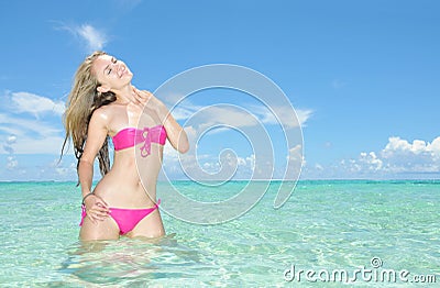 Beautiful woman stand in the tropical sea Stock Photo