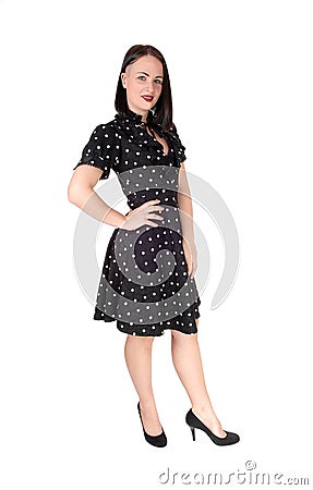 Beautiful woman standing in an pock dot black dress Stock Photo