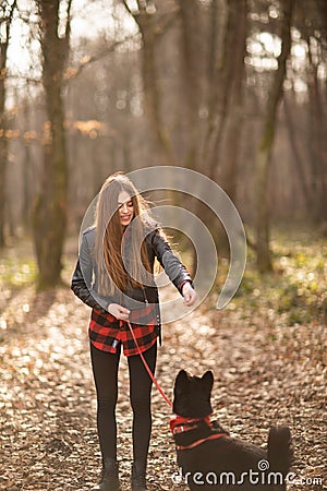 Beautiful woman stroking her dog outdoors. Pretty girl playing and having fun with her pet by name Brovko Vivchar Stock Photo