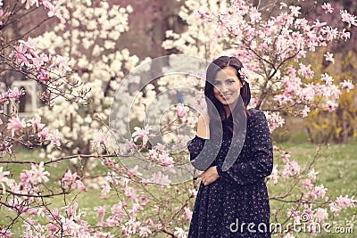 Beautiful woman surrounded by flowers Stock Photo