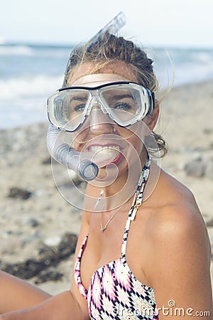 Beautiful woman with swimming goggles on the beach Stock Photo