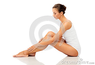 Beautiful woman touching her smooth bare legs Stock Photo