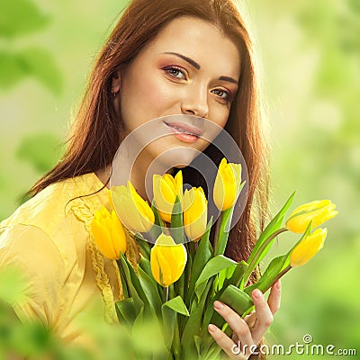Beautiful woman with tulips bouquet of flowers Stock Photo