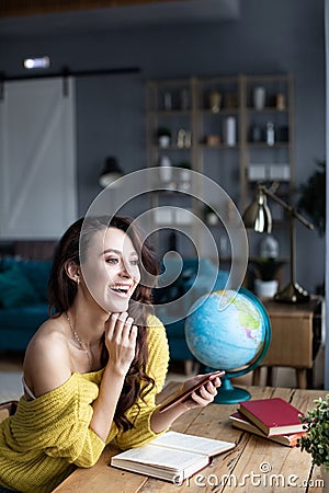 Beautiful woman uses a smartphone Stock Photo