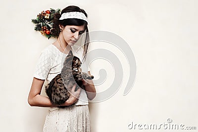 Beautiful woman in vintage dress holding cute funny kitten with Stock Photo