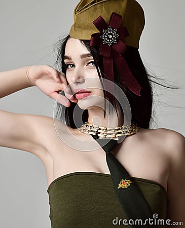 Beautiful woman wear fashion military cloth dark green hat uniform on holiday day of victory May 9 Russia Stock Photo