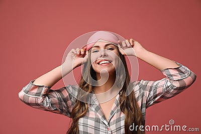 Beautiful woman wearing pajamas and sleeping mask on dusty background. Bedtime Stock Photo