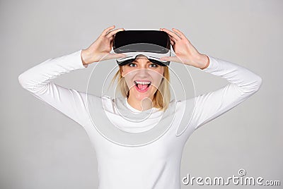 Beautiful woman wearing virtual reality goggles in studio. Excited smiling businesswoman wearing virtual reality glasses Stock Photo