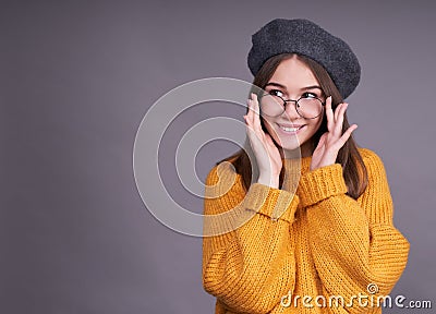Pleasant sweet young girl adjusts glasses on her face Stock Photo