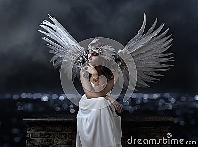 Beautiful woman in white dress with angel wings on a background Stock Photo