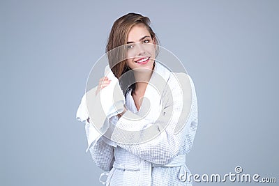 Beautiful woman wiping hair. Girl wrapped in towel with wet hairs. Natural hair. Smiling girl enjoying pure fresh hair Stock Photo