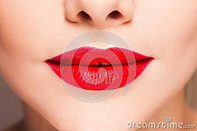 Beautiful women`s lips with bright red lipstick, stylish makeup. Stock Photo