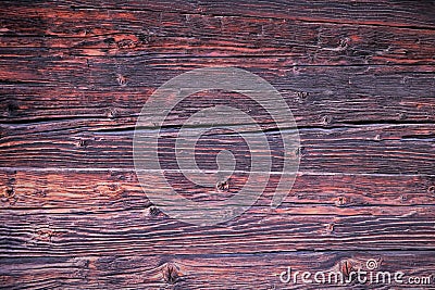 Background. Beautiful wooden boards, the wall of a wooden antique house in brown, red and pink tones. Stock Photo