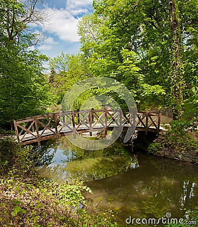 Beautiful wooden footbridge across river Stock Photo