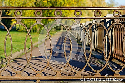 Beautiful wrought iron lattice in the park in autumn Stock Photo