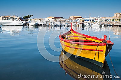 A beautiful yellow boat in Marzamemi harbour, Sicily Editorial Stock Photo