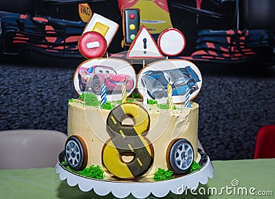 Beautiful yellow cake with gingerbread in the form of cars and road signs Editorial Stock Photo