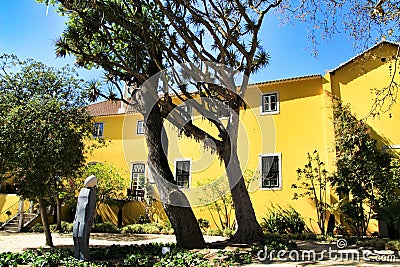 Beautiful yellow house with colorful garden in Lisbon Stock Photo