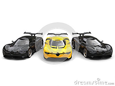 Beautiful yellow super car with two black sports cars on each side Stock Photo