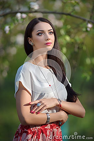 Beautiful yong model wearing luxury accessory in blooming spring Stock Photo