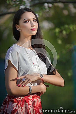 Beautiful yong woman wearing luxury accessory in blooming spring Stock Photo