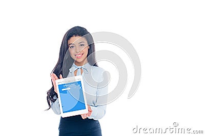 beautiful young african american woman holding digital tablet with twitter application on screen and smiling at camera isolated Editorial Stock Photo