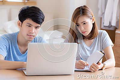 Beautiful young asian couple calculate expenses finance with laptop and planning together Stock Photo