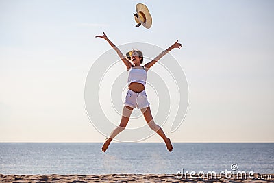 beautiful young asian woman excited throwing hats up on the air at the sea beach . Happy girl enjoy holidays vacation . Stock Photo