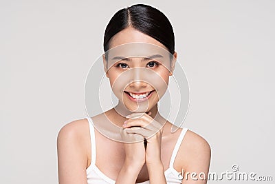 Beautiful Asian young woman touching soft cheek smile with clean and fresh skin Stock Photo