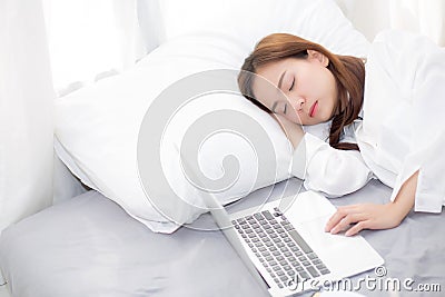 Beautiful young asian woman with laptop lying down in bedroom, girl tired sleep with computer notebook. Editorial Stock Photo