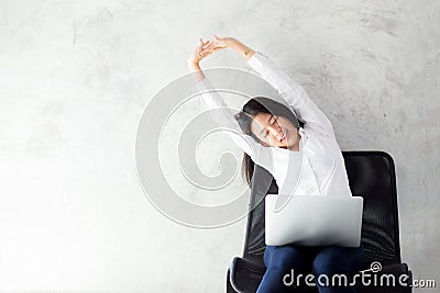 Beautiful young asian woman with laptop stretch and exercise relax after work success. Stock Photo