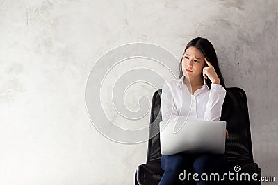 Beautiful young asian woman working and thinking with problem to stress and unhappy Stock Photo