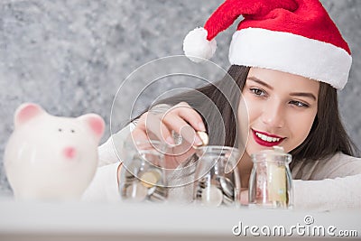 Beautiful young beautiful girl saving money for Christmas and holiday season Stock Photo