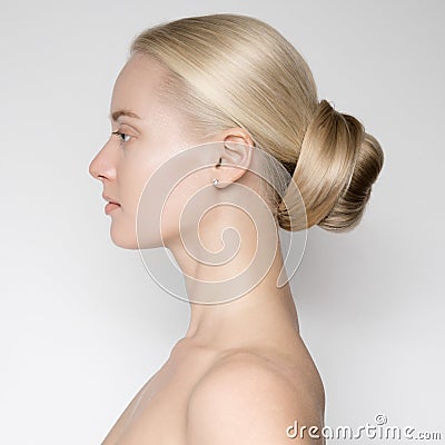 Beautiful Young Blond Woman With Bun HairstÑƒle. Stock Photo