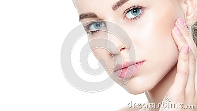 Beautiful Young Blond Woman with Perfect Skin touching her face. Facial treatment. Cosmetology, beauty and spa concept. Stock Photo