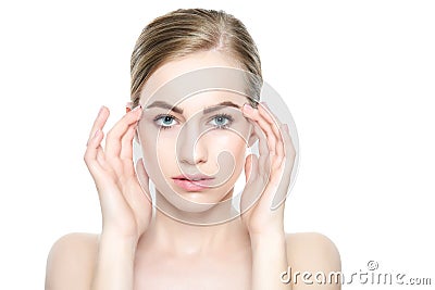 Beautiful Young Blond Woman with Perfect Skin touching her face. Facial treatment. Cosmetology, beauty and spa concept. Stock Photo