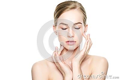 Beautiful Young Blond Woman with Perfect Skin touching her face. Facial treatment. Cosmetology, beauty and spa concept. Stock Photo