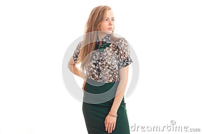 Beautiful young blonde girl in blouse and skirt posing on camera by unscrewing the head towards Stock Photo