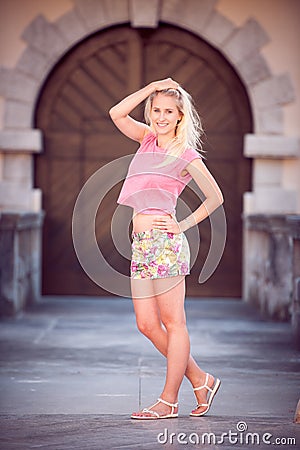 Beautiful young blonde woman on a walk around the city Stock Photo