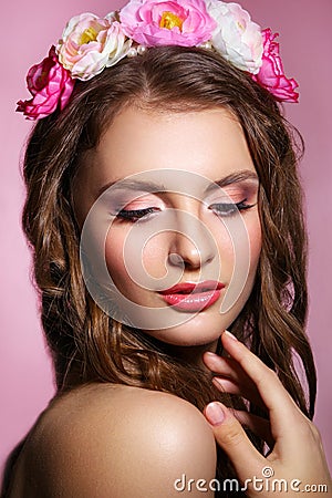 Beautiful young bride with a floral ornament in her hair.Beautiful Woman Touching her Face. Youth and Skin Care Concept Stock Photo