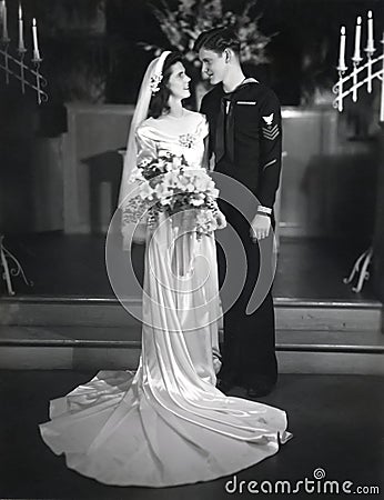 Beautiful young bride marries a young sailor in 1944 Stock Photo