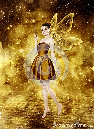 Beautiful young brunette woman as golden fairy Stock Photo