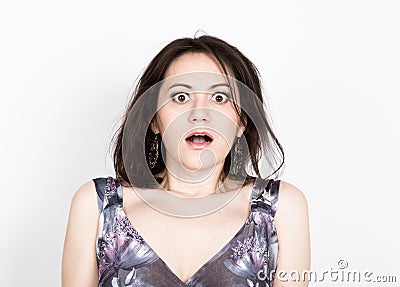 Beautiful young brunette woman in a colorful dress posing and expresses different emotions. girl's hands shows various Stock Photo