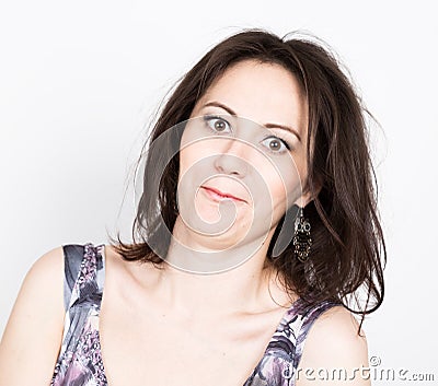 Beautiful young brunette woman in a colorful dress posing and expresses different emotions. girl's hands shows various Stock Photo