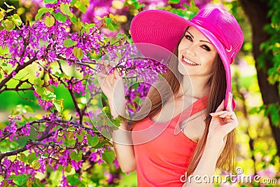 Beautiful young brunette woman on the meadow with white flowers on a warm summer day Stock Photo