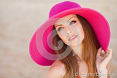 Beautiful young brunette woman on the meadow with white flowers on a warm summer day Stock Photo