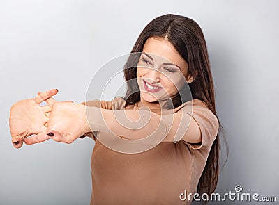 Beautiful young business woman relaxing and stretching in beige blouse on blue background. Portriat closeup healthy Stock Photo